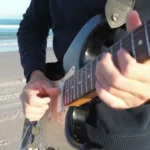 Sultans Of Swing Guitar Loop guitarist playing on the beach