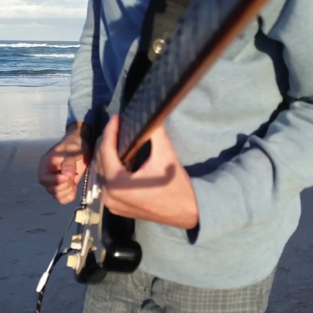 Guitarist looping 'Let's Groove' by Earth, Wind & Fire on the beach