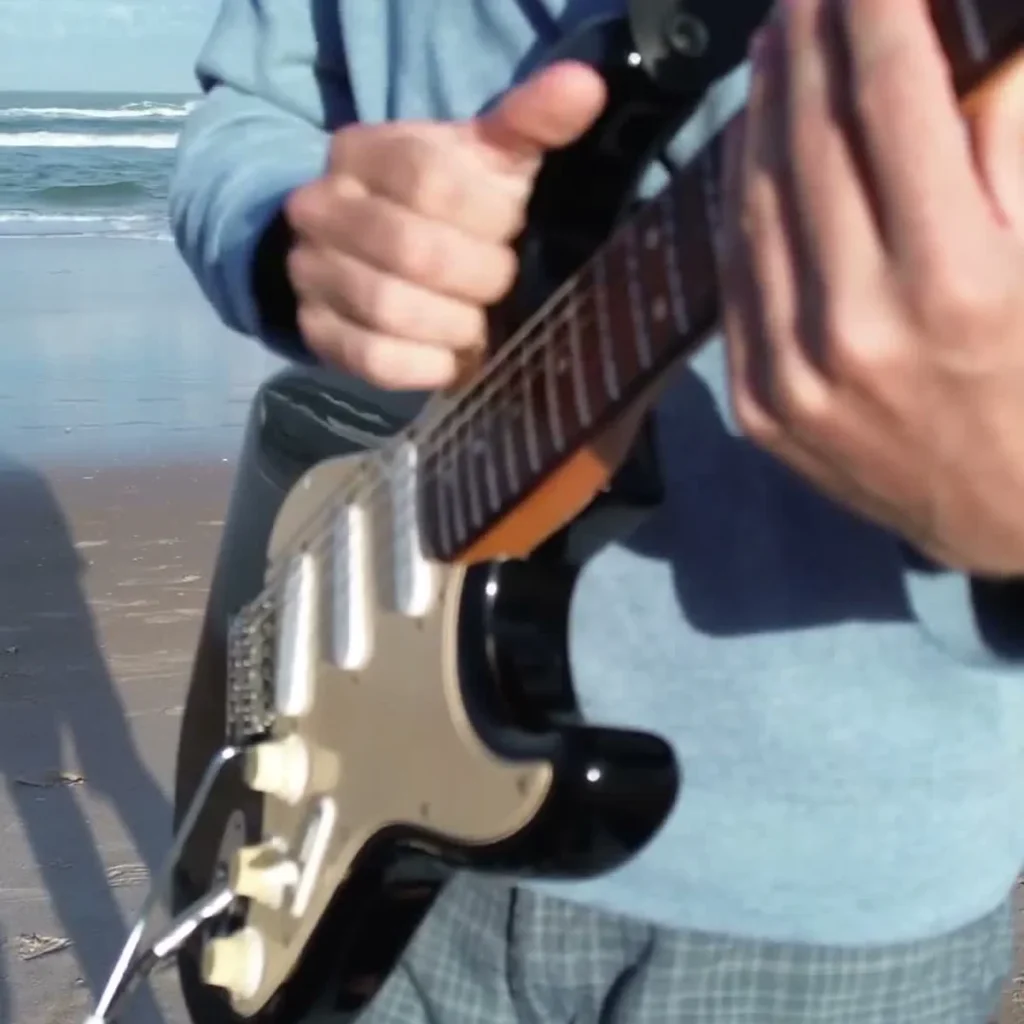 Guitarist looping Lady (Hear Me Tonight) at the beach