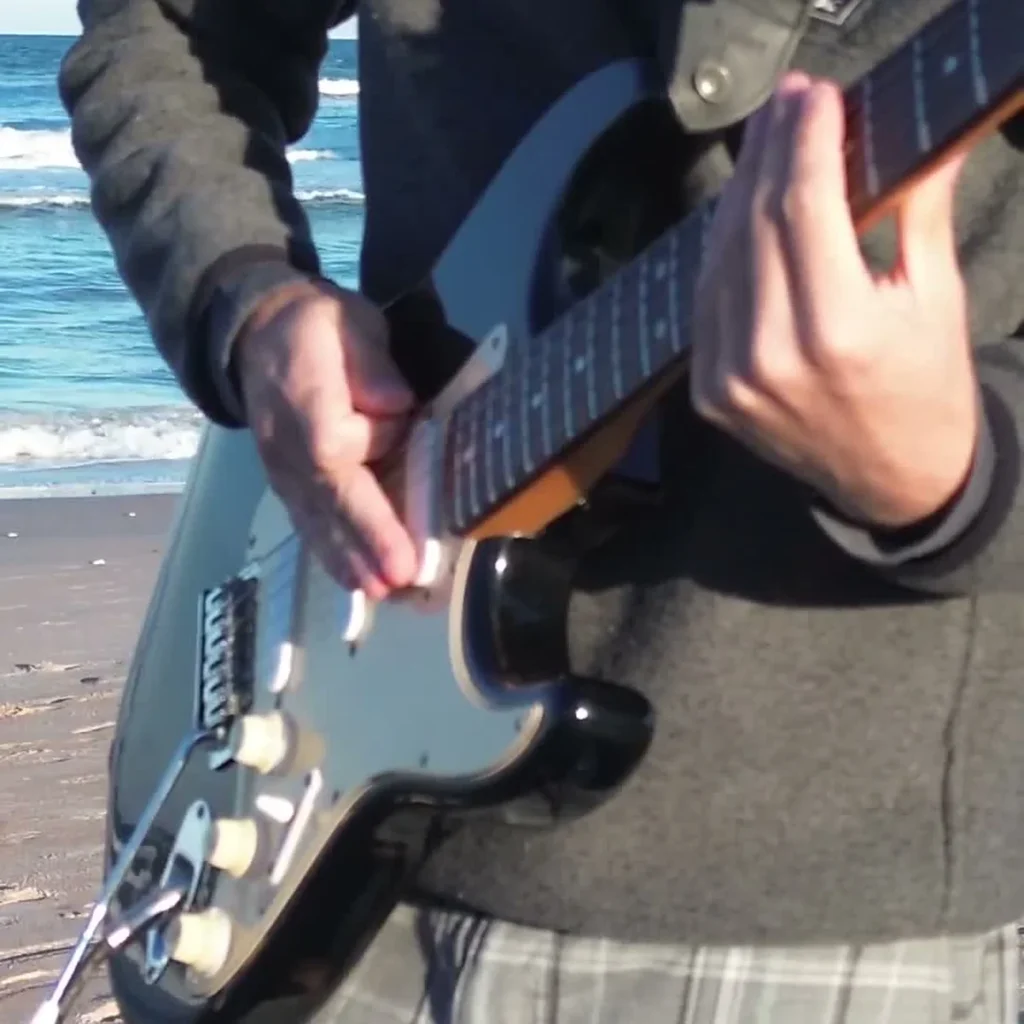 Orinoco Flow Guitar Loop guitarist at the beach one guitar loop session by the ocean