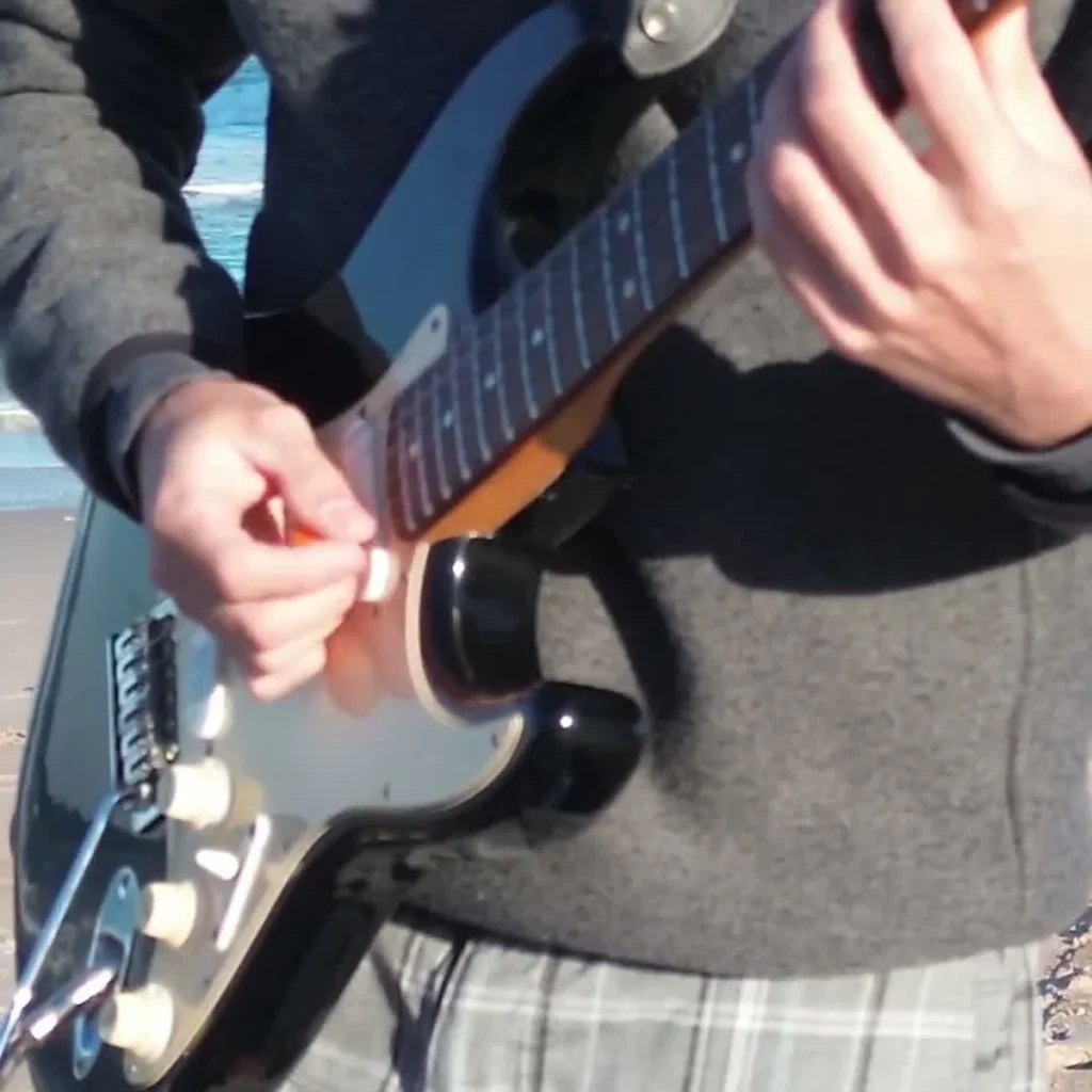 Funkytown Guitar Loop guitarist playing by the ocean